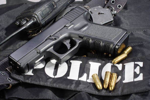 istock Police weapon and equipment on black uniform background 914241832