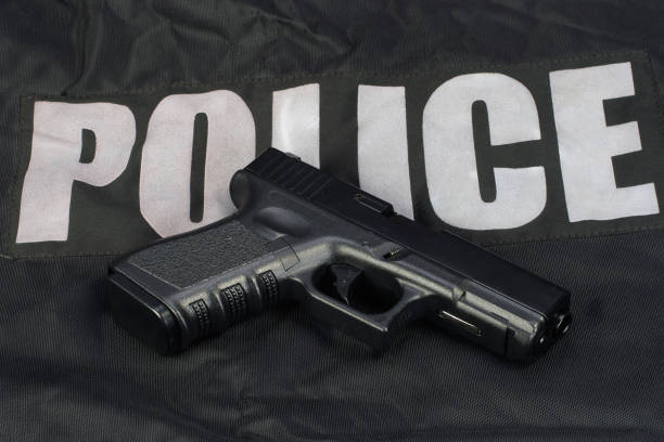 istock Police weapon and equipment on black uniform background 914242050