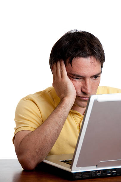 istock Man in yellow shirt works on a laptop computer. 91424239