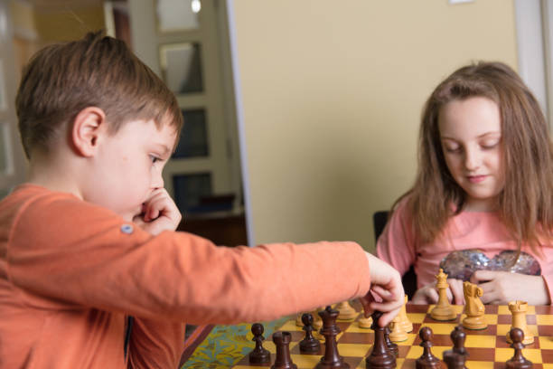 istock Brother and sister playing chess 914245418