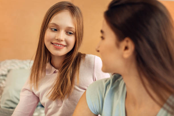 istock Pleasant girl looking at her elder sister with smile 914249842