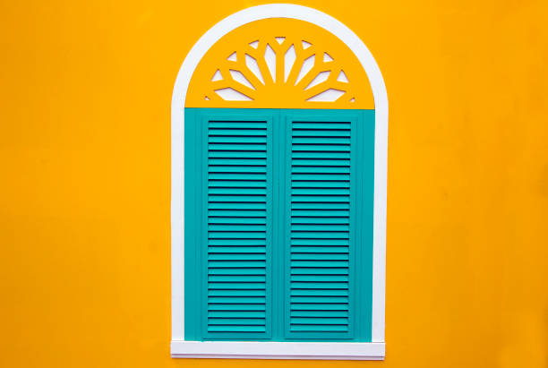 window on the yellow wall stock photo