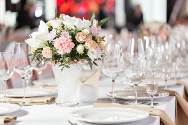 istock Tables set for an event party or wedding reception. luxury elegant table setting dinner in a restaurant. glasses and dishes. 914253802