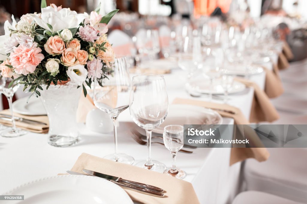Tables set for an event party or wedding reception. luxury elegant table setting dinner in a restaurant. glasses and dishes. Tables set for an event party or wedding reception. luxury elegant table setting dinner in a restaurant. glasses and dishes Wedding Stock Photo