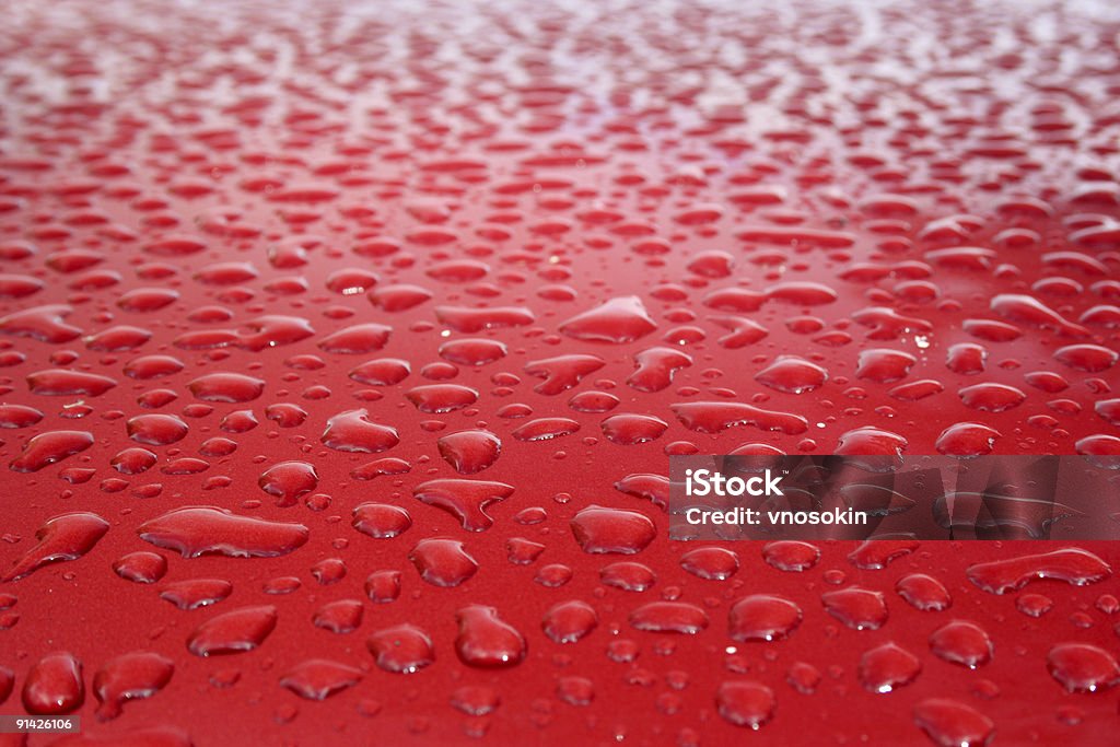 Water drops on red Water drops on the red metallic surface. Abstract Stock Photo