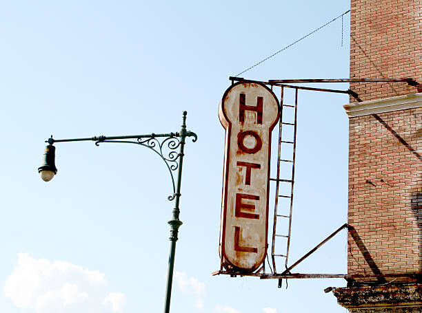 istock Old Hotel Sign On Building With Period Lamp Post 91426479