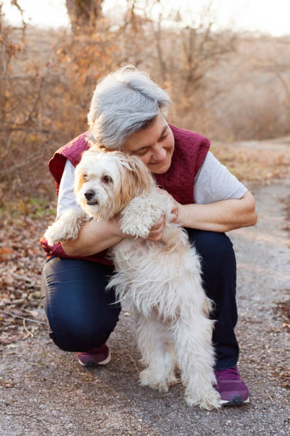 istock senior woman with dog 914275990