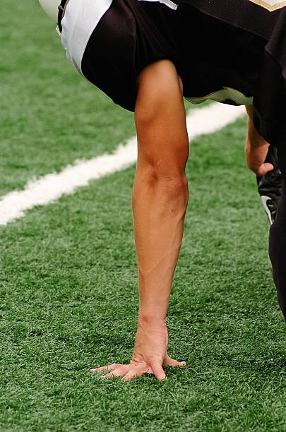 istock Football players hand on field while he stretches 91428660