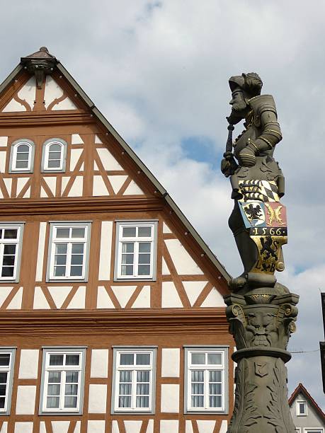 istock Fountain figure in front of a half-timbered house 91428967