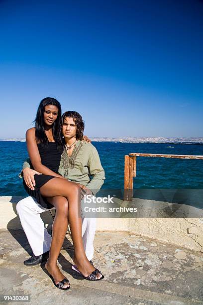 Young Couple At The Seaside Stock Photo - Download Image Now - 20-29 Years, Adult, Adults Only
