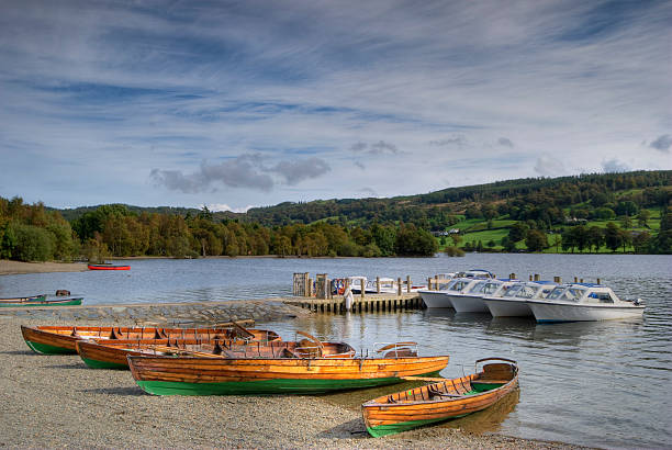 Beautiful glowing sunset on a calm spring evening with a rowing boat at Crummock Water in the Lake District
