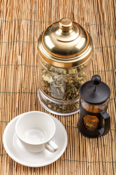 istock Winter composition with linden tea and ceramic cups on wooden floor. 914311124
