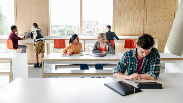 istock Multi racial group of college students working in modern building interior 914314260