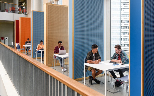 Row of colourful booths for student study, separated by partitions, providing privacy and space to work and meet