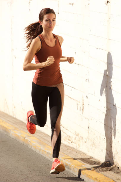 istock Female athlete on morning run outdoors on road 914314624