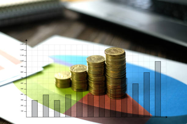 istock Step of coins stacks with notebook laptop computer and financial graph on white paper on working table, business planning vision and finance analysis concept. 914317054