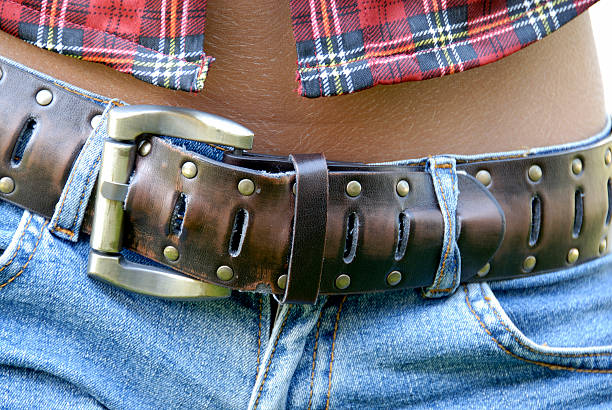 Belt against bronzed skin stock photo