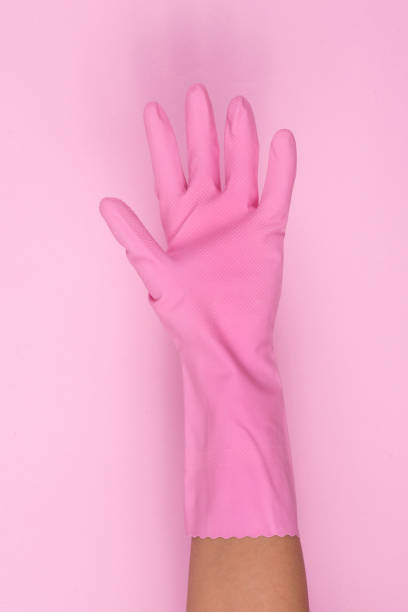 istock pink  glove on hand shows number five. 914324560