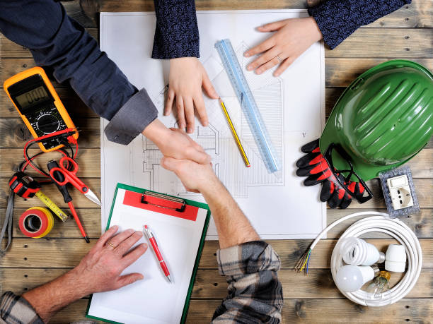 istock Young architects and technicians analyze the project of a residential house 914327254