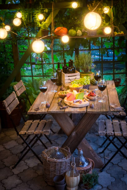 istock Preparation for dinner with snacks and wine in the garden 914331398