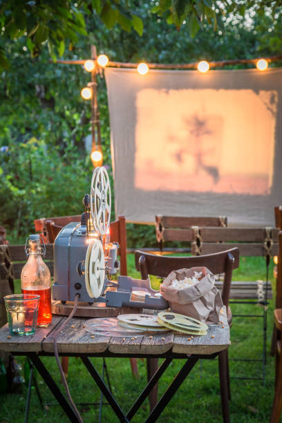 istock Open-air cinema with retro projector in the garden 914331484