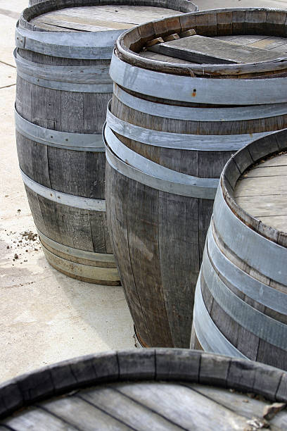 Wooden barrels stacked outside stock photo