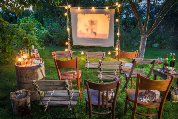 istock Summer cinema with retro projector in the garden 914333692