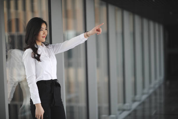 istock Young asian businesswoman pointing 914339982