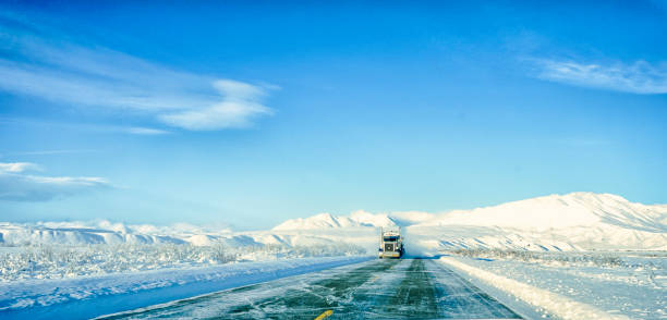 Transportation in Winter Winter does not stop the need for transportation in Alaska.  On this frigid day, goods travel down the Richardson Highway.  The beauty of Alaska encompasses this mode of transportation sundog stock pictures, royalty-free photos & images