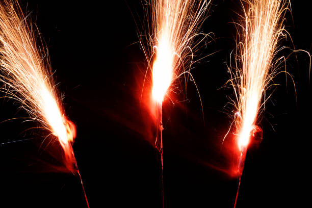 istock Long Exposure Three Sparklers Burning Bright Against Dark 914342954