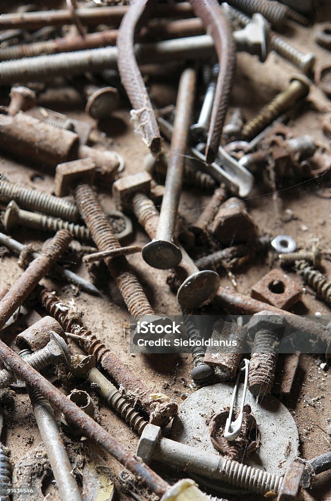 Old rusty bolts and nails / tools. Focus on front.  Abandoned Stock Photo