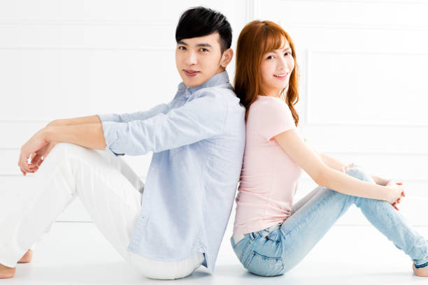 istock Young couple sitting together on the floor 914346194