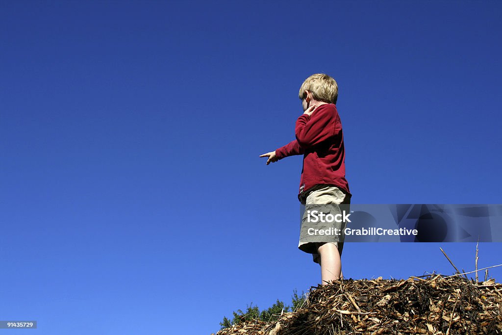 That Way! Young boy stands on a hill pointing  Adventure Stock Photo