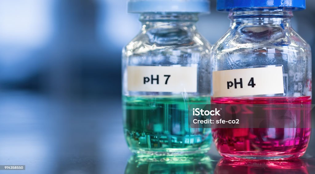 pH 7 (green) and 4 buffer (red) solutions in glass bottles pH 7 (green) and 4 buffer (red) solutions in glass bottles. Labels separately printed and adhered. These calibration solutions are commonly found in science laboratories where meters are used to measure sample acidity or alkalinity. Acid Stock Photo