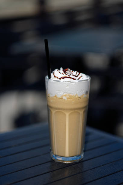 istock latte macchiato coffee with cream in tall glass with straws on a dark table 914361562