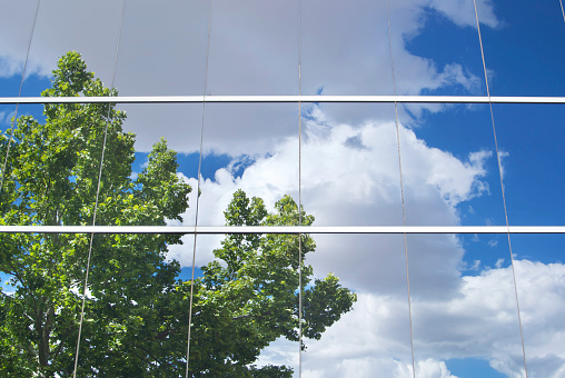 The reflection of the sky and clouds combine with the grid window layout of 180 Maiden Lane to form an abstract image.