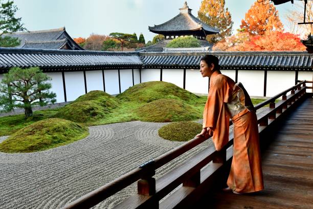 Japanese Woman in Kimono Appreciating Japanese Garden at Tofukuji, Kyoto A Japanese woman in kimono, in her 40’s, is appreciating Japanese rock garden at Hojo (the former living quarters of the head priest) of Tofuku-ji Temple in Kyoto. This garden is called Eastern Garden, the largest of the four gardens surrounding Hojo, and it is composed of four rock groups symbolizing Elysian islands on the rough seas. rinzai zen buddhism stock pictures, royalty-free photos & images