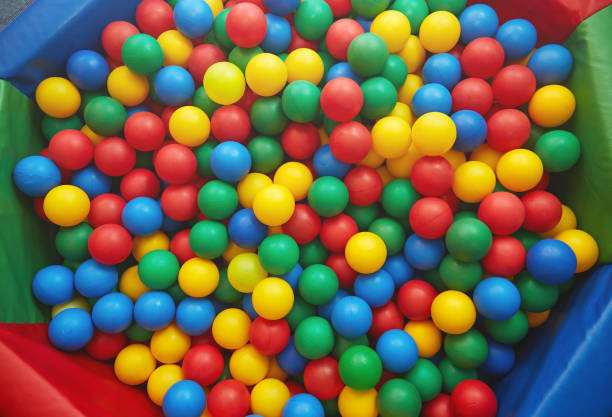 group of many multicolored plastic balls. close-up view - ball pool imagens e fotografias de stock