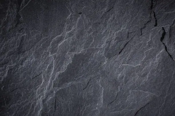 Photo of Dark grey and black slate background or texture