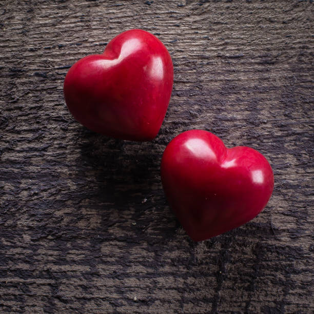 istock Red Ceramics Hearts on wooden table. Valentine background 914382176