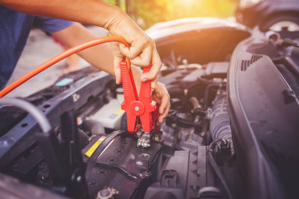 Check voltage level car battery. Close up of auto mechanic jumping battery car,check voltage level car battery,helping concept. car battery stock pictures, royalty-free photos & images