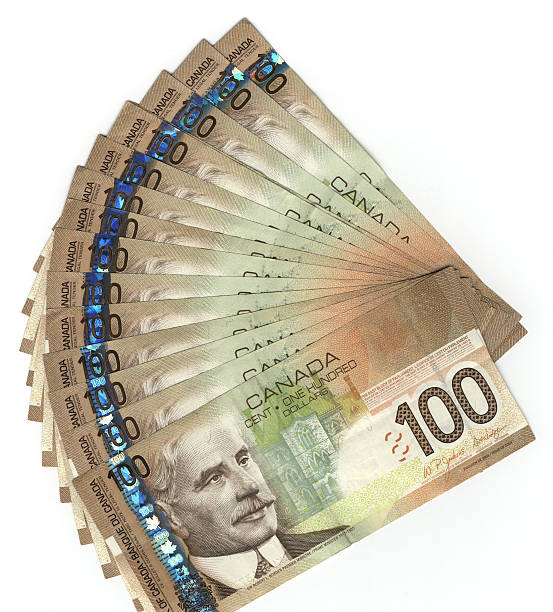A stack of Canadian hundred dollar bills isolated on white