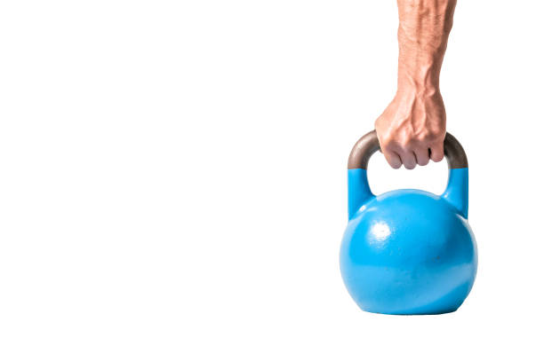 istock Strong muscular man hand with muscles holding blue heavy kettlebell partially isolated on white background 914389676