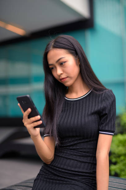 istock Young Asian Woman Using Mobile Phone 914393046
