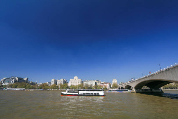 Hurlingham Party Boat on Thames River, London, cruising past Shell House in the background