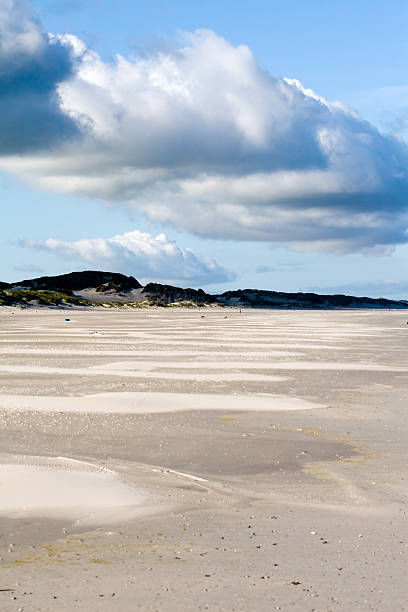 Empty beach in the sunny morning sun stock photo