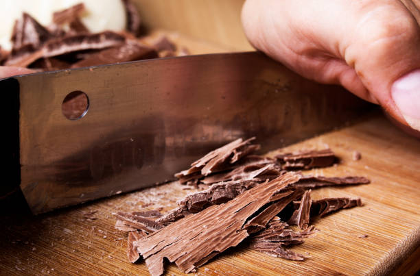 istock Dark chocolate being cut on a cutting board with a knife 914406282