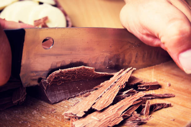 istock Dark chocolate being cut on a cutting board with a knife 914407872
