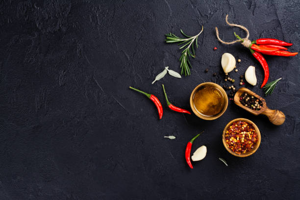 istock Fresh herbs and spices on black stone table 914410756
