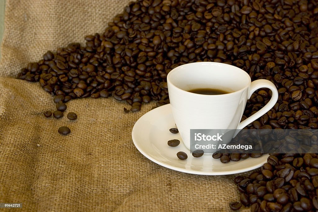 Fresh coffee Hot fresh coffee on burlap between coffee beans Addiction Stock Photo